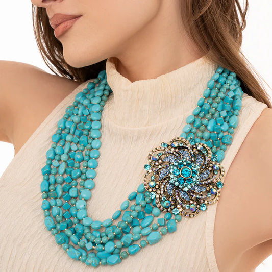 Collana multi linee con pietre turchesi, inserto fiore in metallo